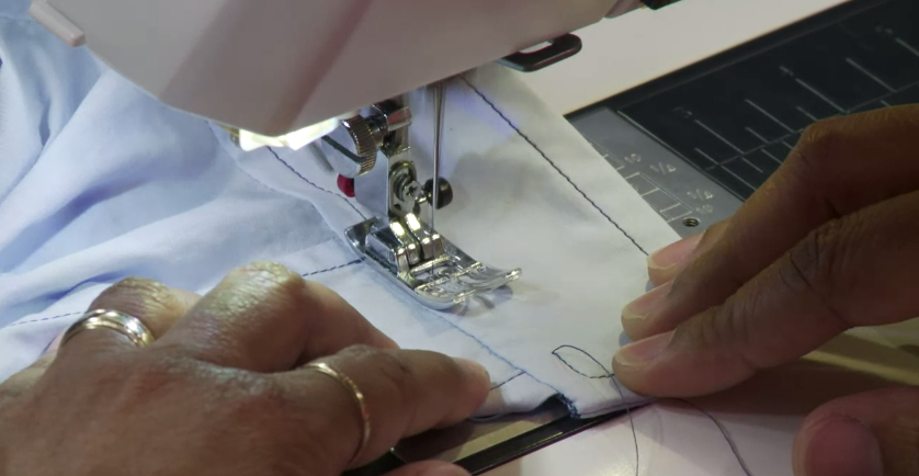 Woman Sewing Cuff on Sewing Machine