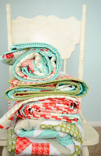 Stacks of Quilts on a White Chair