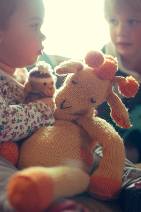 Baby Holding Stuffed Knit Giraffe