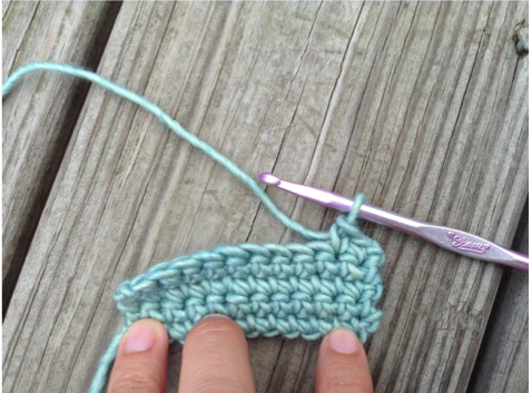 View of Stitched Crocheted Piece and Crochet Needle
