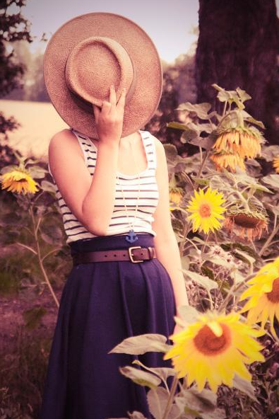 Woman in Sunflower Field Modeling Nautical Skirt, Holding Hat Over Face