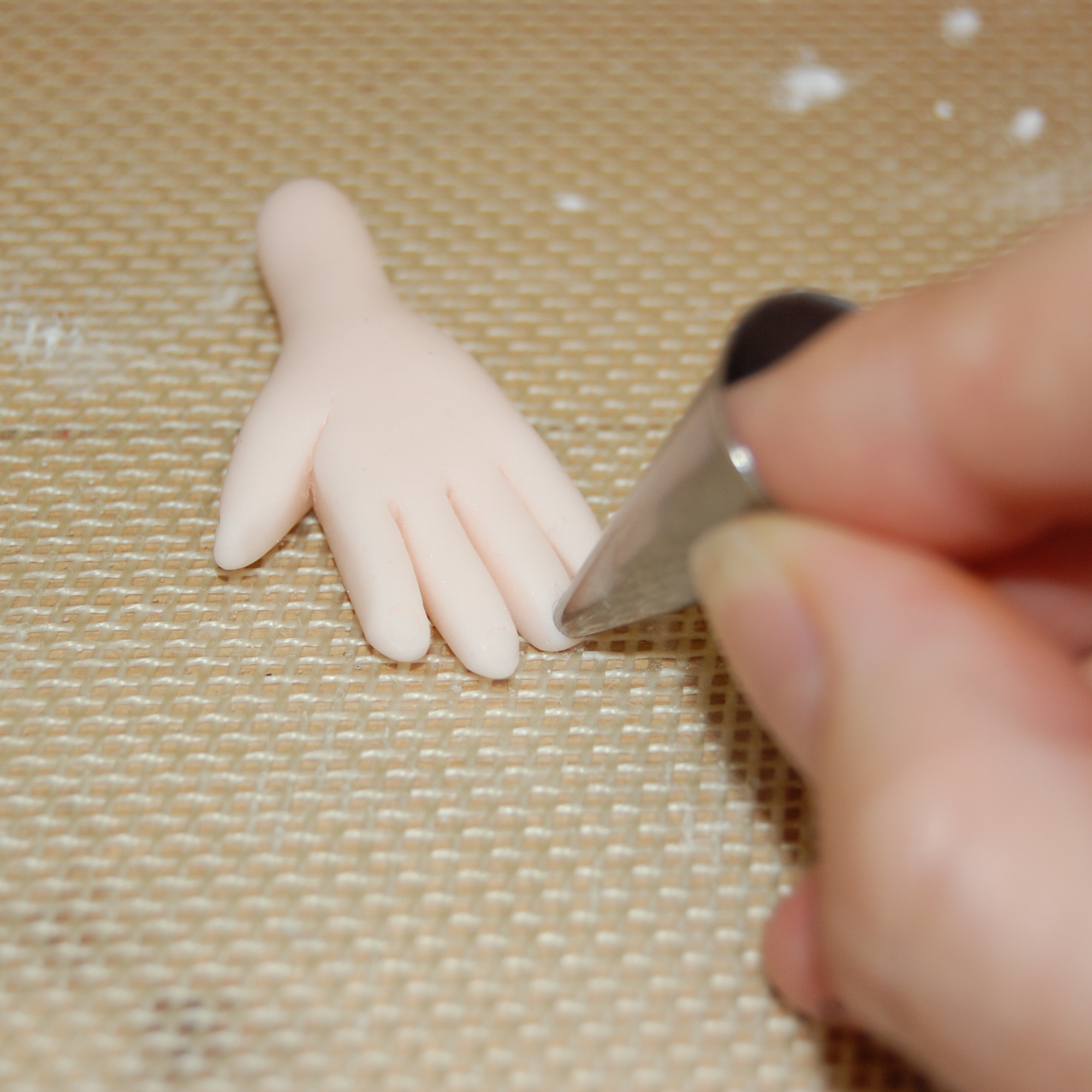 Hand Using Piping Tip to Create Fingernails