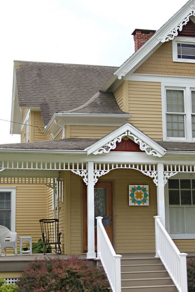 Yellow Country House with Barn Quilt by Door 