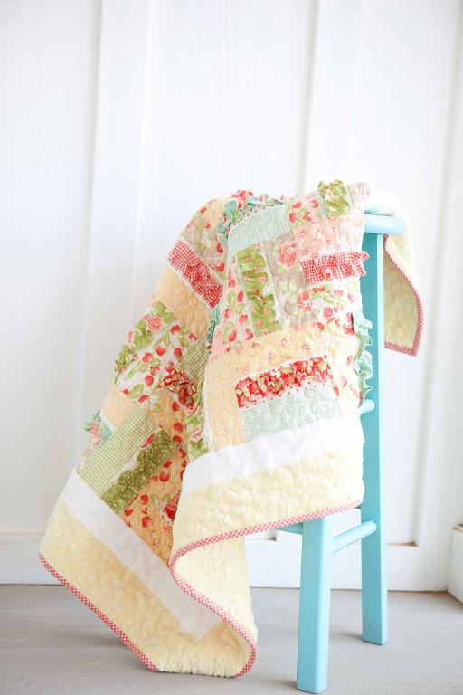 Quilt Hanging Over a Blue Ladder