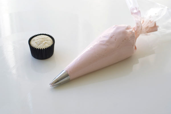 Icing Bag Filled with Pink Frosting by Naked Cupcake