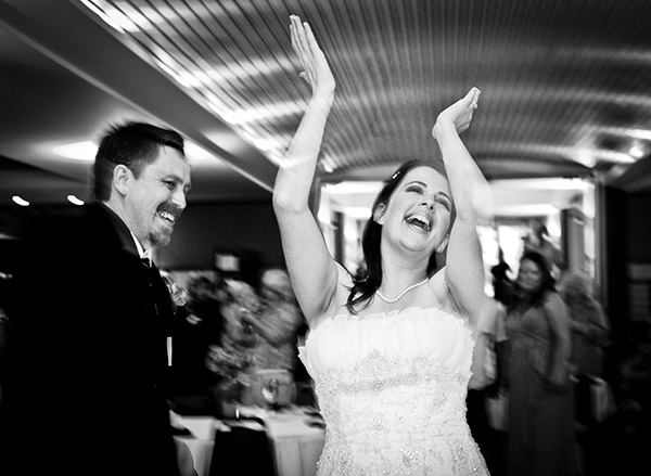 Black and White Image of Bride and Groom on Dance Floor, Bride Clapping 