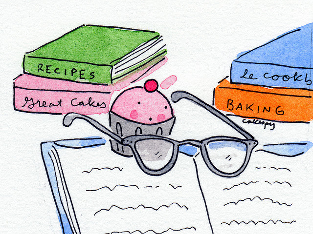 Cartoon of Cupcake Using Glasses to Read a Cookbook