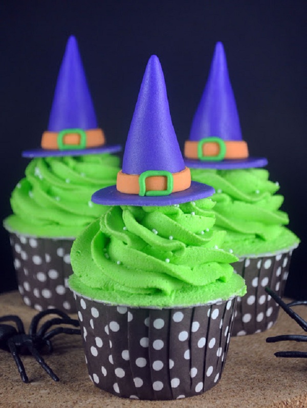 Blue Witch Hats Atop Green Frosting on Cupcakes 