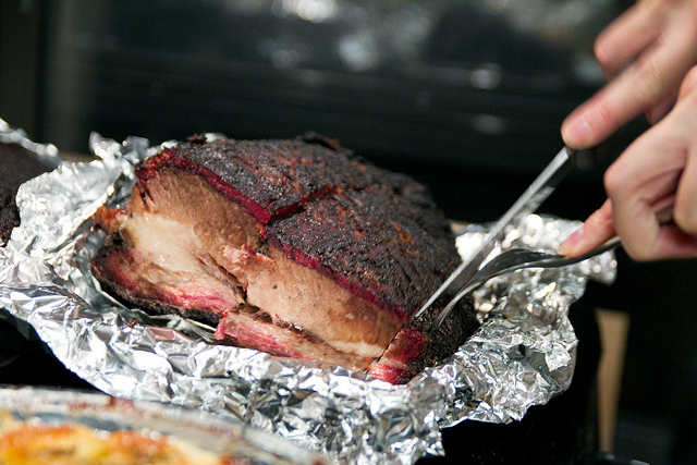 Beef in Foil Being Cut 