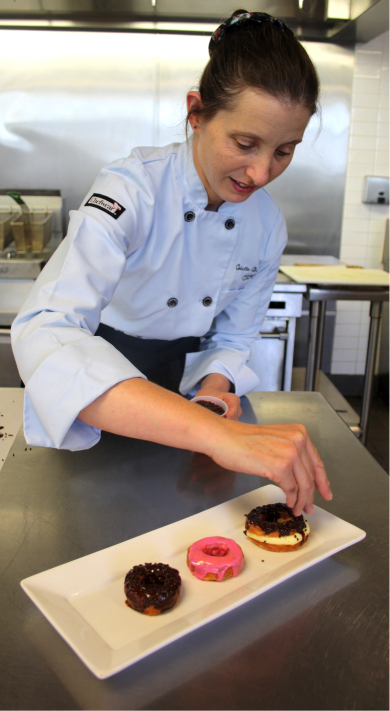 Woman Putting Finishing Touches onto Cronuts