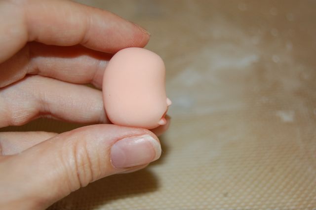Hand Holding Fondant Heat, Profile of Head with Nose and Pouting Lip