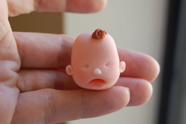 Hand Holding Sad Baby Face
