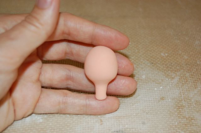 Hand Holding Piece of Formed Fondant 