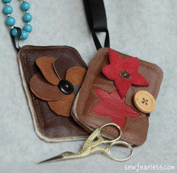 Two Leather Needle Shields with Floral Decoration