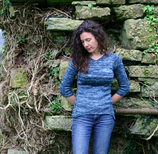 Carol Feller Leaning Against Stones, Modeling Blue Sweater