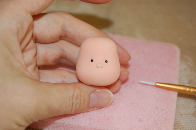 Piece of Fondant with Sprinkle Eyes and Little Fondant Nose
