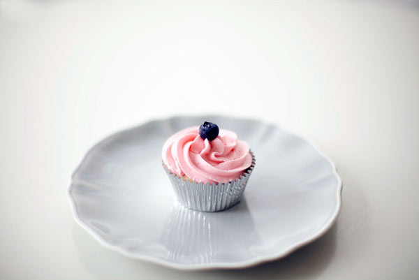 Cupcake with Pink Icing and Little Blueberry on Top