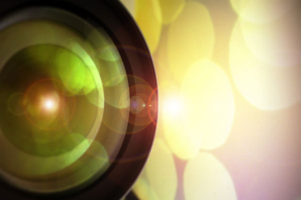 Close-up on Camera Lens, Blurred Light in Background