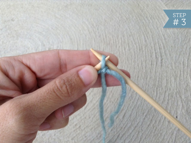 View of Hand Holding Knitting Needles with Slip Knot