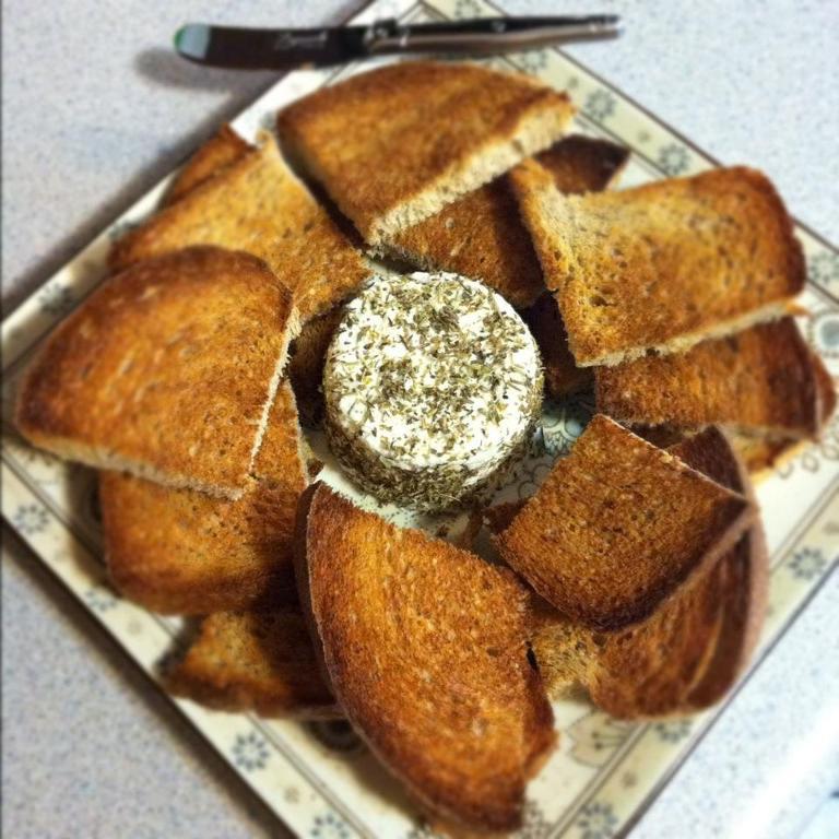 Pieces of Bread Around Herb-Crusted Goat Cheese