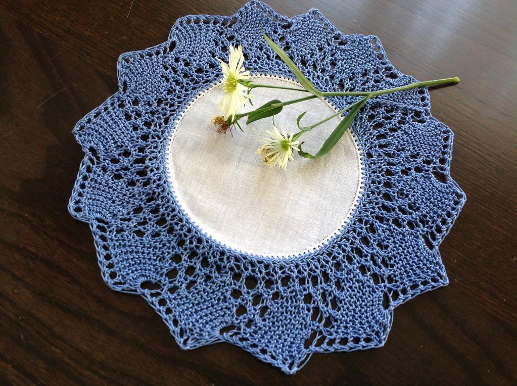 Knitted Blue and White Doily with Flowers on It 