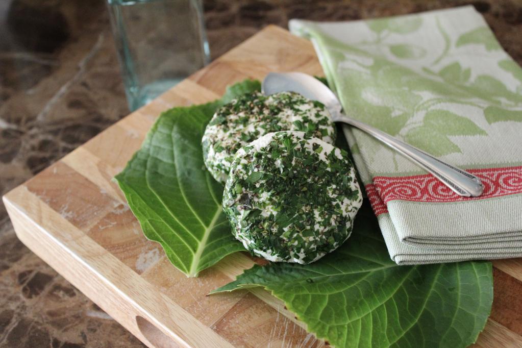 Herb Crusted Goat Cheese on Board with Fresh Herbs and Napkin