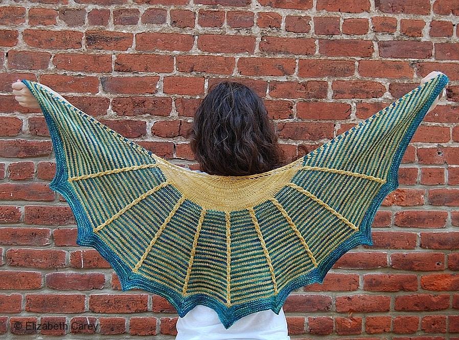 Woman Holding up Gardener's Shawl Against Brick Wall