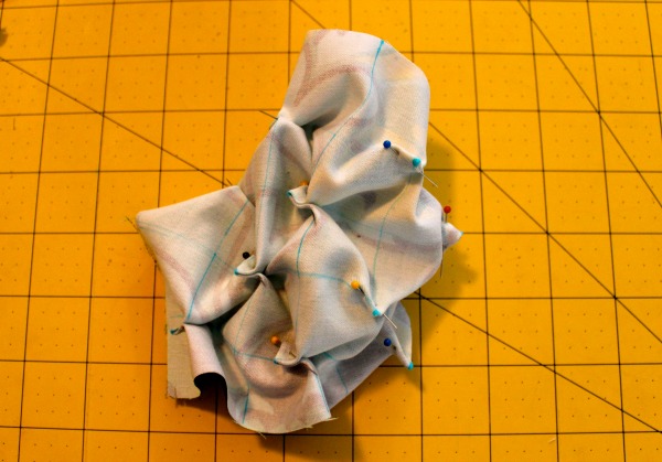 Piece of Fabric Furrowed and Pinned on Measuring Table