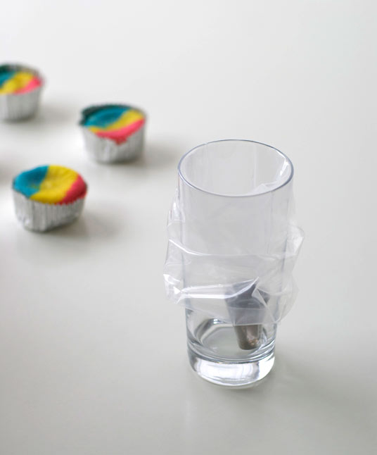 Icing Tip and Icing Bag Inside of Tall Glass, Edges Folded Over Sides of Glass