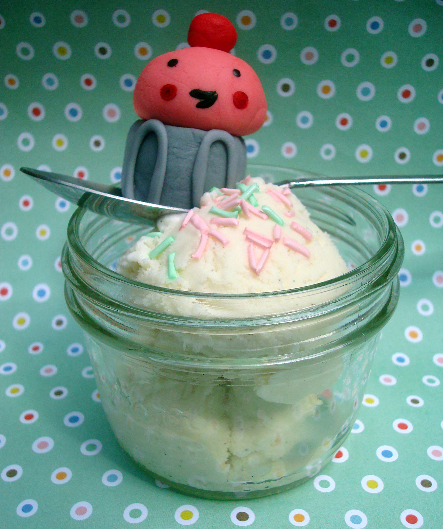 Fondant Figure Sitting in Bowl of Ice Cream with Sprinkles on Top