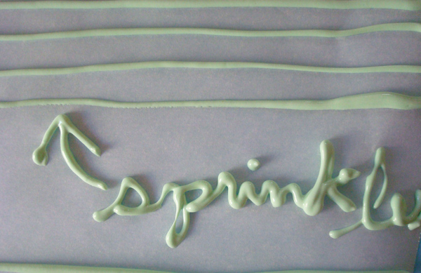 Icing on Parchment Paper, Text Made of Icing Reading 