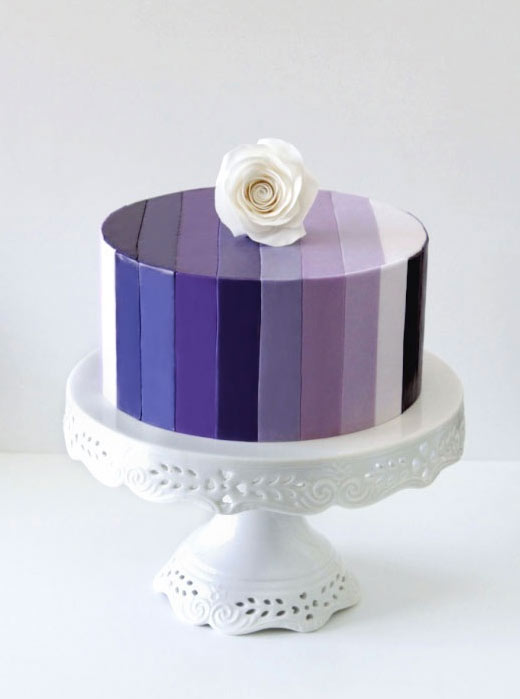 Purple and Blue Hued Striped Cake Topped with White Rose