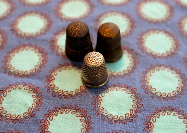 Three Thimbles on Patterned Background