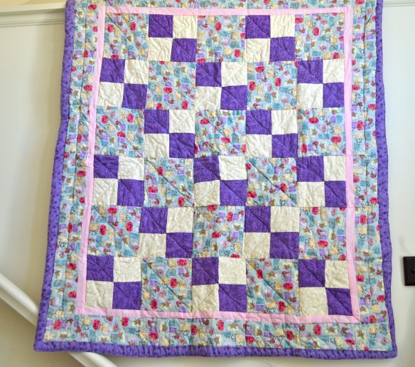 Quilt Featuring Purple, White and Patterned Blocks