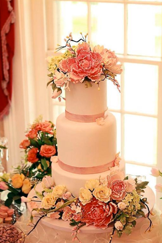 Pale Pink Tiered Cake Topped with Ruffled Sugar Flowers