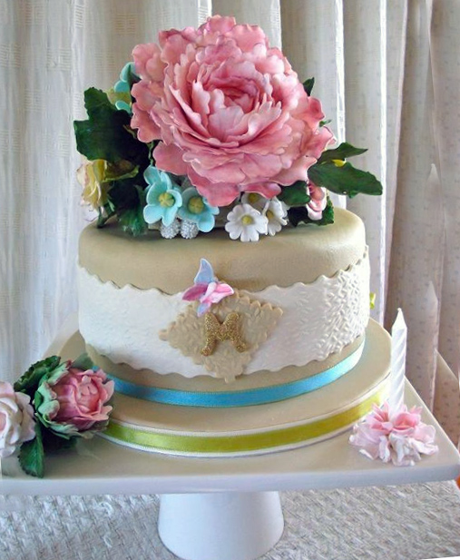 Tiered Gold and White Cake Topped with Exquisite Blossom