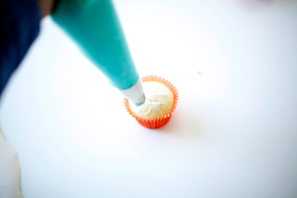 Beginning to Frost the Cupcake with Buttercream 