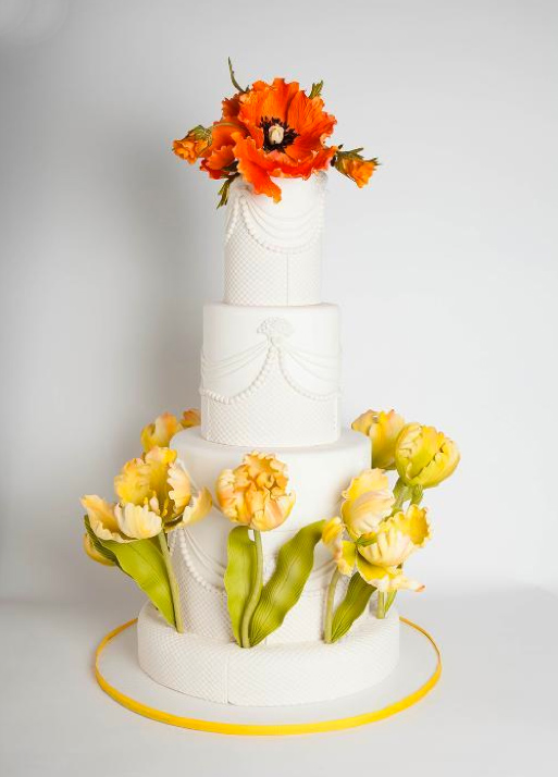 Tiered White Cake Topped with Orange and Yellow Sugar Flowers