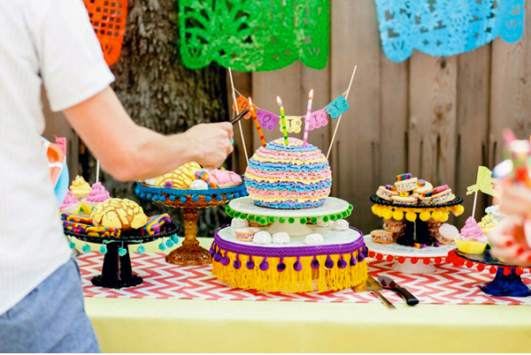 Lighting Candles on Cake on Fiesta Dessert Table