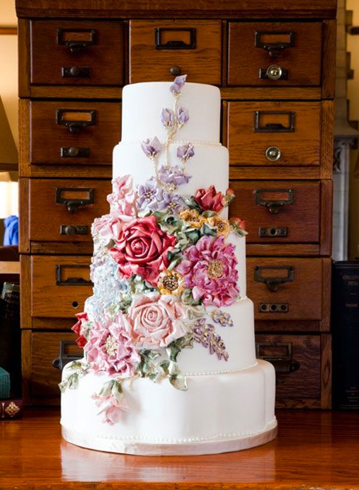Tiered White Cake Featuring Colorful Multitude of Sugar Flowers