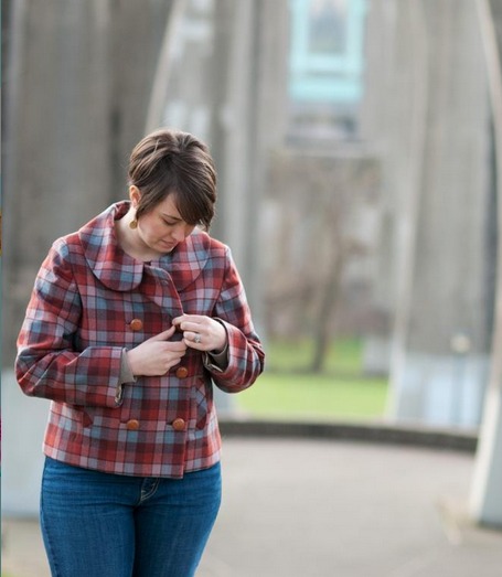 Woman Buttoning up Plaid Coat 