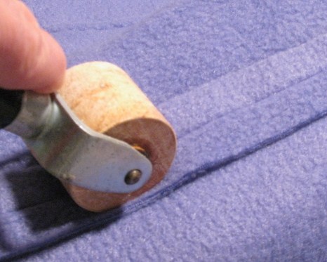 Using Wallpaper Roller to Flatten Fabric