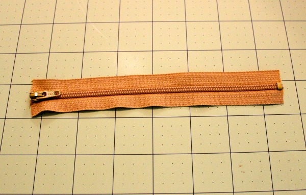 Zipper Laying Across a Marked Mat 
