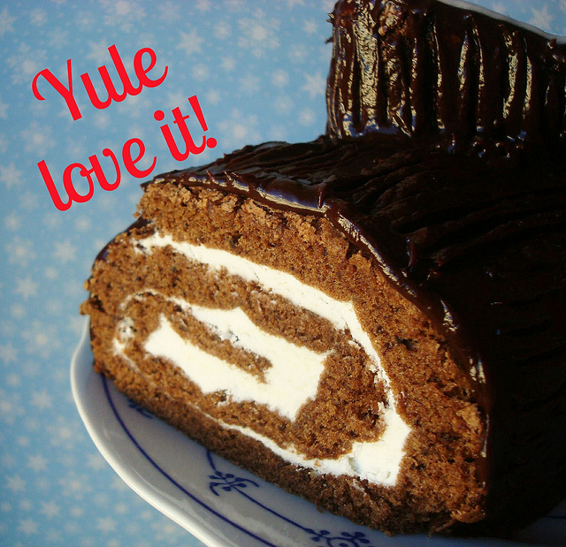 Photo of Yule Log Cake Reading "Yule Love it!"