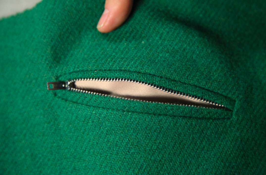 Kenneth Displays a Zippered Pocket on a Garment 