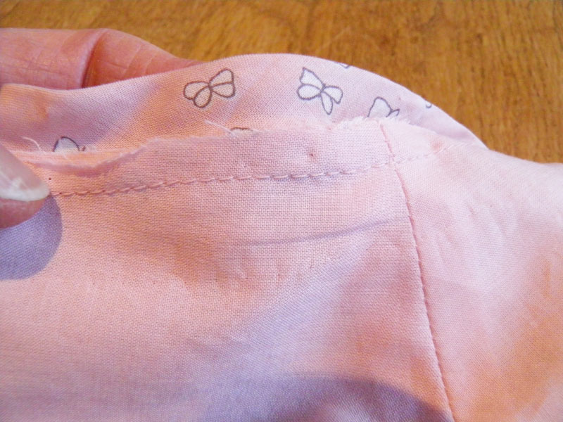 Machine stitched bias binding to neckline