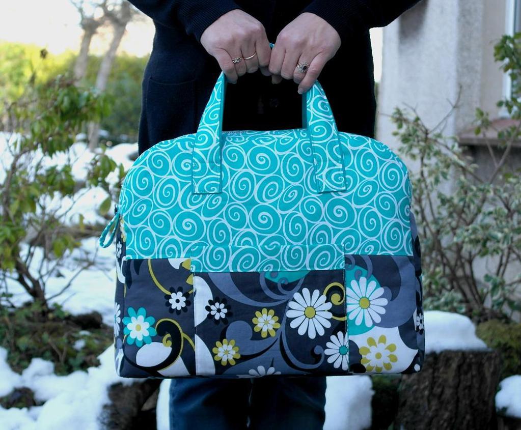 Woman Holding Blue Patterned Travel Bag