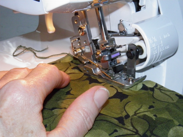 Beginning second side serging of rolled hem