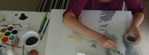 working on a table with watercolors