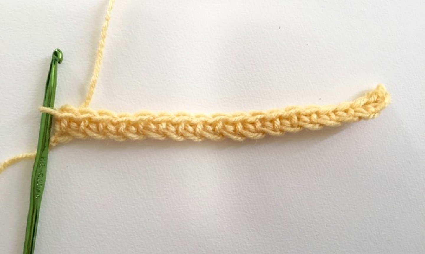 Cadena de hilo amarillo con gancho verde